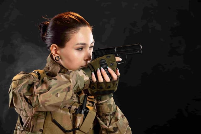 girl aming a pistol to the right